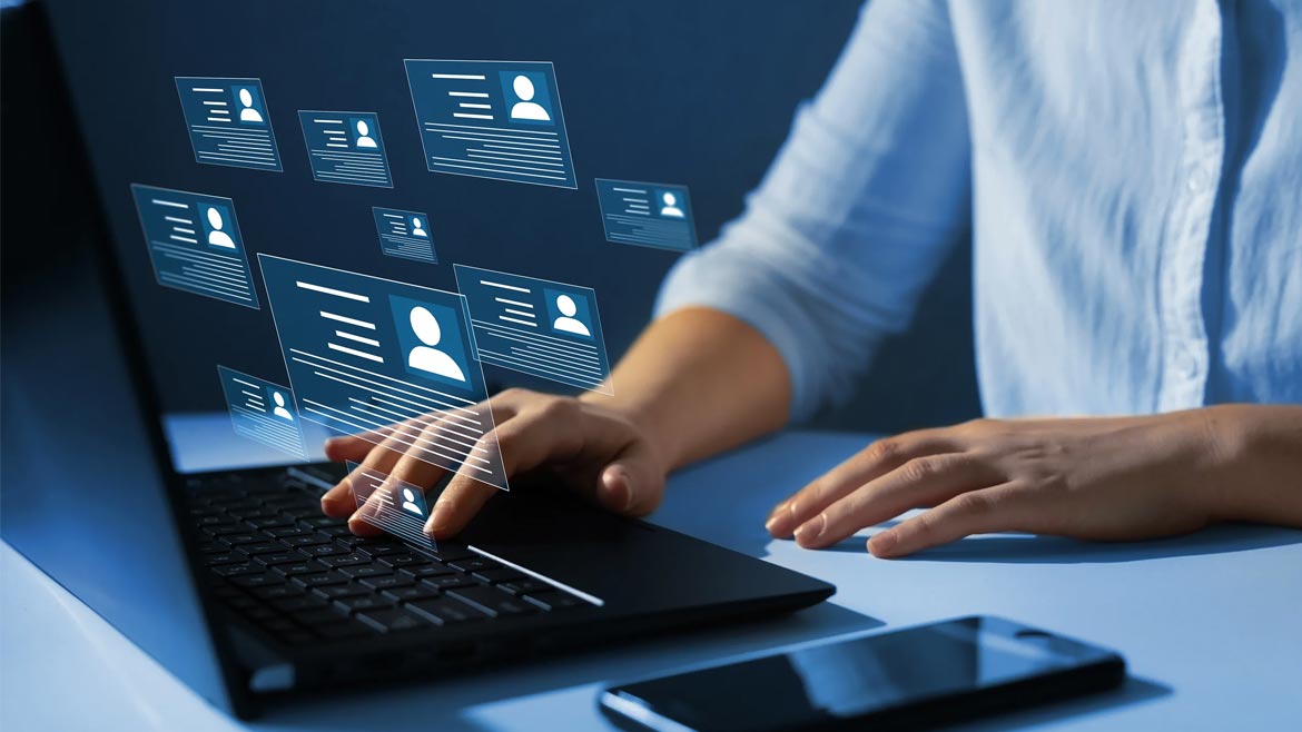 Virtual screens floating above laptop while someone is typing.