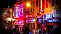 Nashville's Music City at night and lit up by the neon signs.