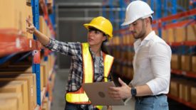 Two warehouse workers going over inventory