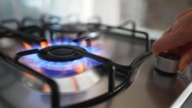 Close up of gas stove burner being turned on.