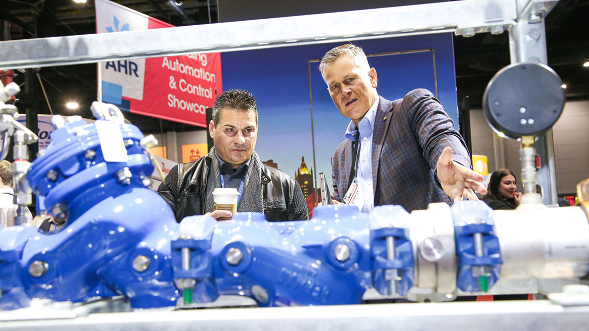 Two people looking at an exhibit at the AHR Expo.